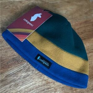 Cotopaxi Unisex Teca Fleece Beanie in Green, Gold, and Blue